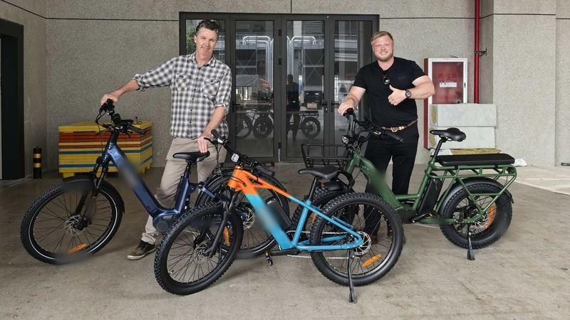 Joe Lindsay and a supplier with three own-brand e-bike samples in China